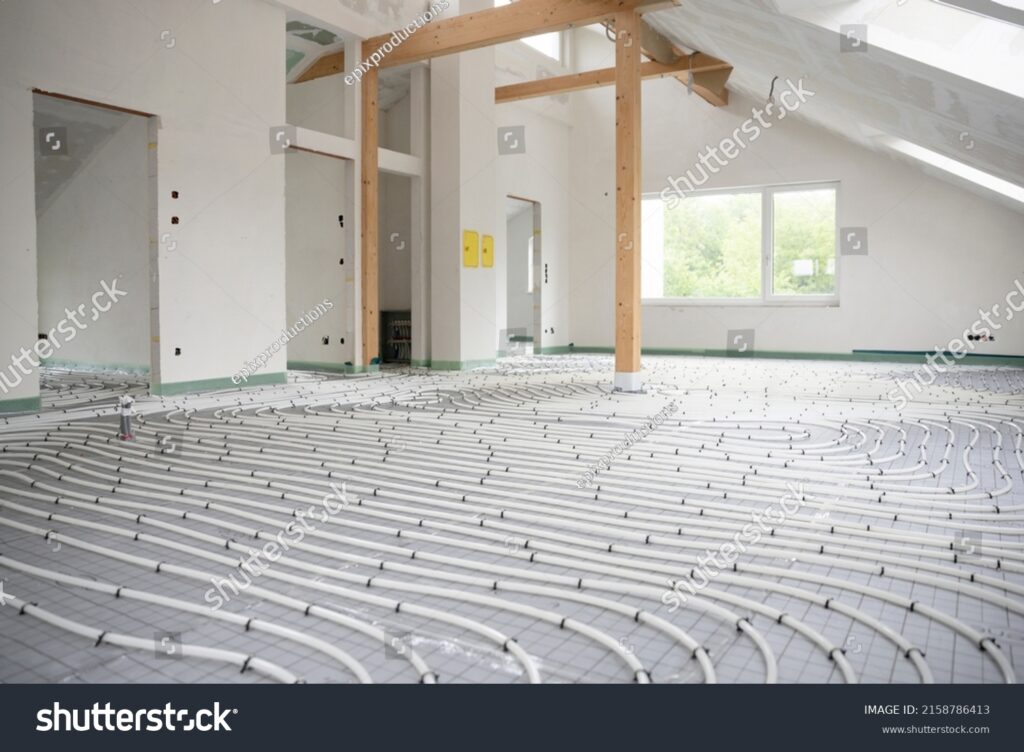 stock-photo-shot-of-construction-site-in-a-loft-where-underfloor-heating-has-just-been-installed-white-pipes-2158786413